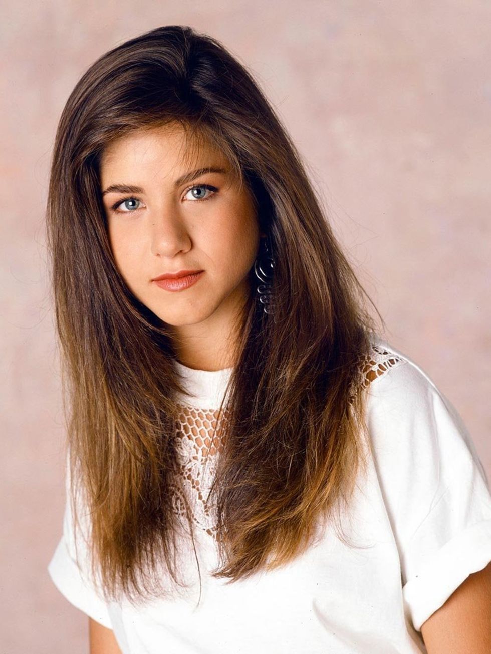 <p>Where it all began: Jen flaunts thick, long hair in 1990.</p>