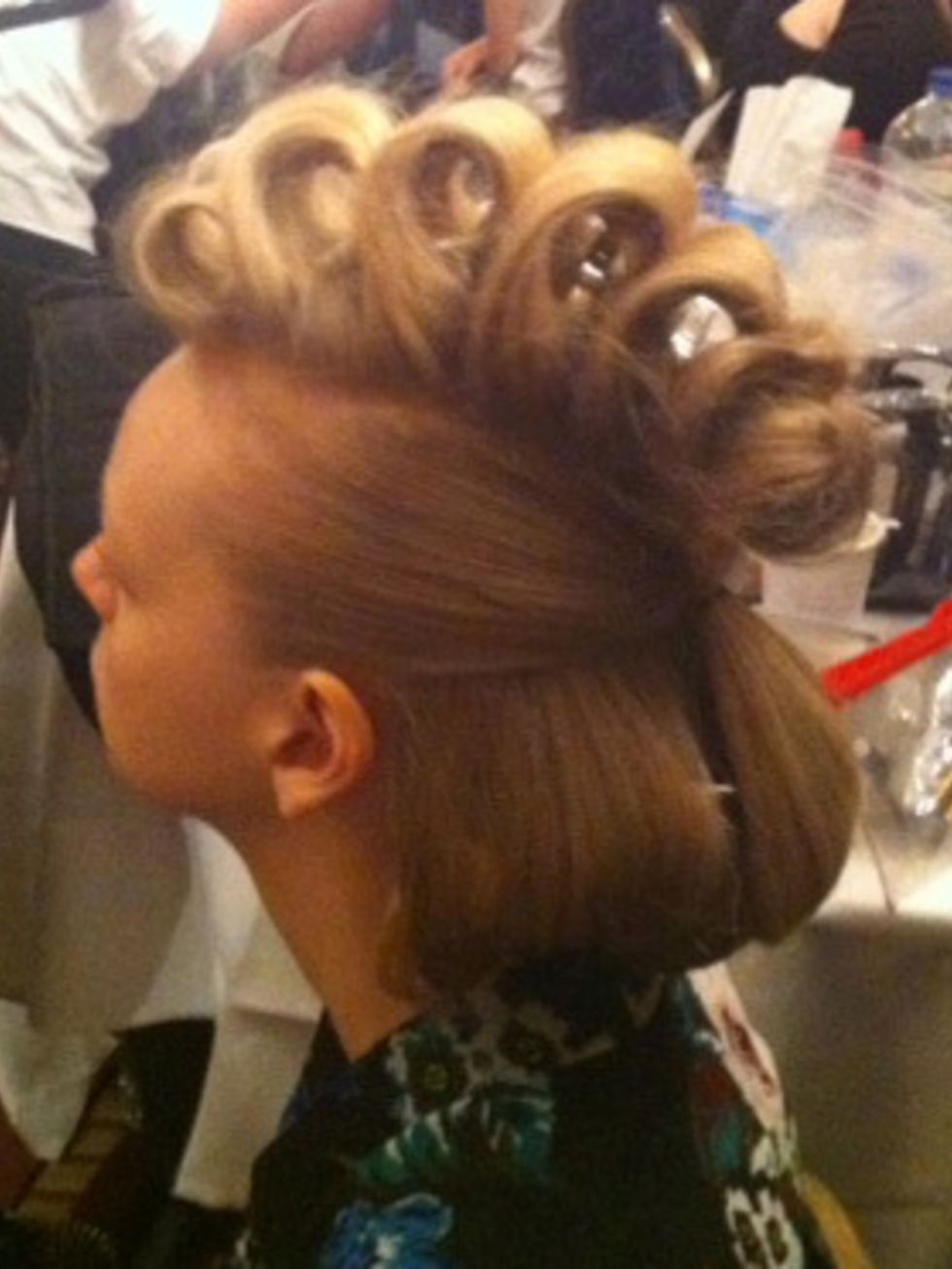 <p>A model's hair is set and ready to be finished backstage at the Teatum Jones show</p>