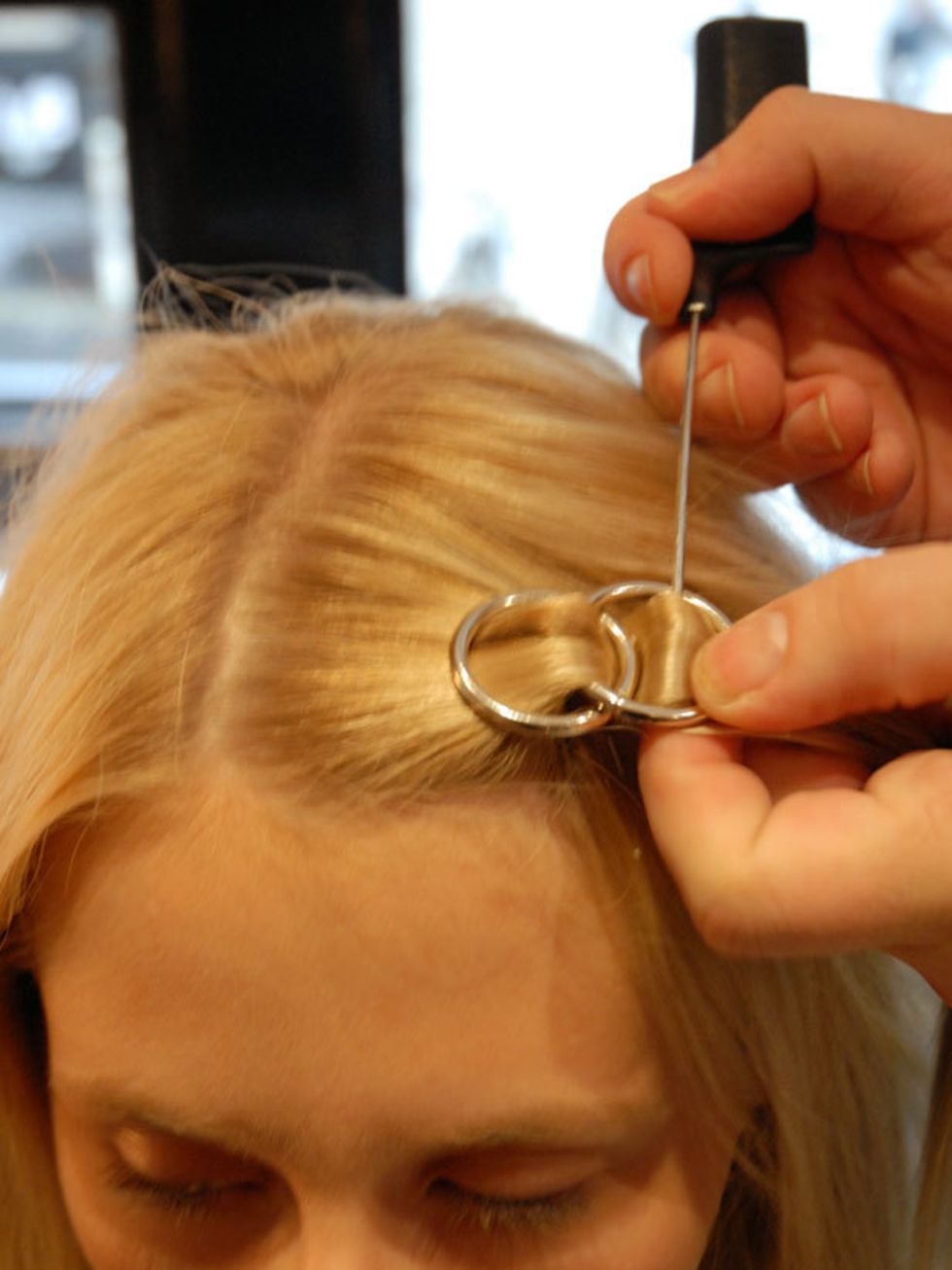 &lt;p&gt;&lt;strong&gt;Step eight:&lt;/strong&gt; Flatten the hoop that is sitting up down in the direction away from your parting and feed the hair under the first hoop and over the flattened hoop.&lt;/p&gt;