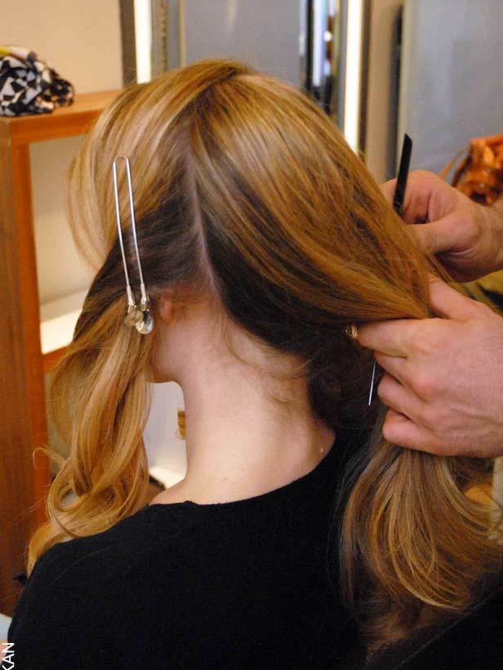 <p><strong>Step Two:</strong></p><p>Split hair into four sections using a tail comb - one section at the front, two at the sides and one at the back.</p>