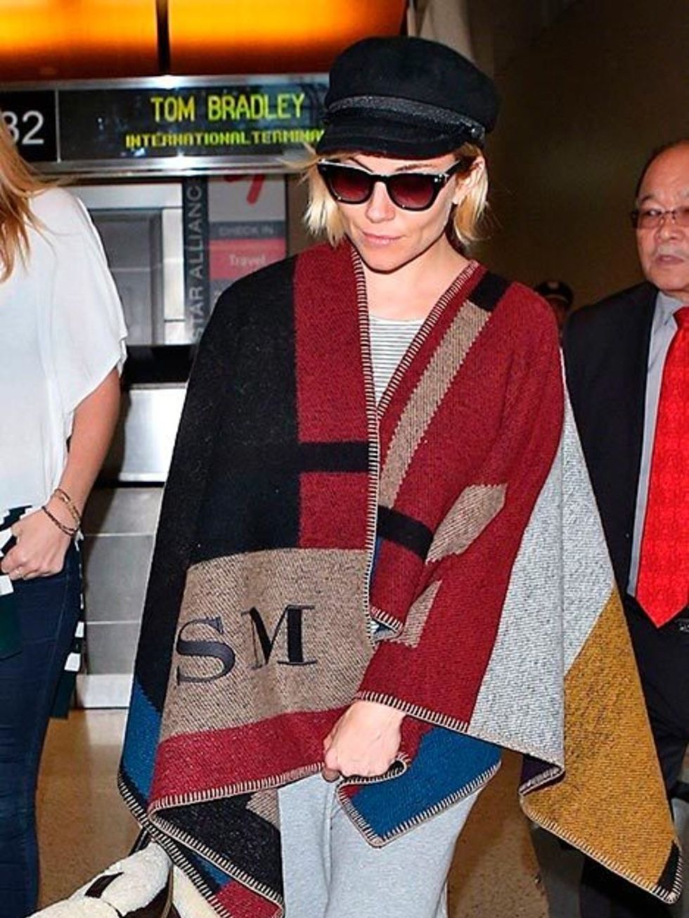Sienna Miller spotted in a Burberry blanket coat at the Los Angeles airport, November 2014.