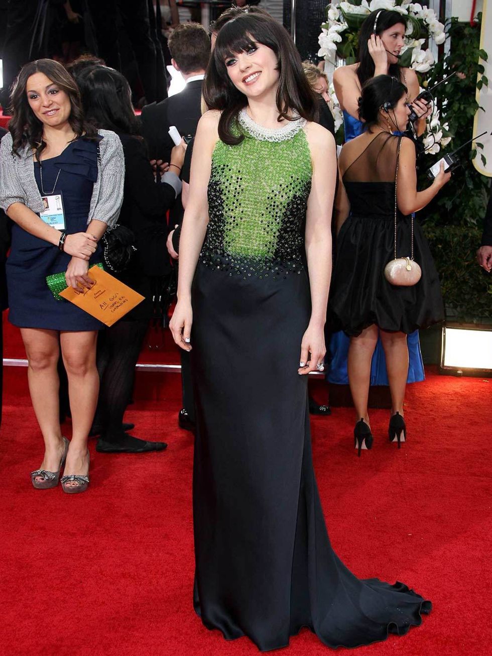 <p>Zooey Deschanel wears a Prada gown embellished with black and moss green glass pearls and a stunning ivory pearl collar to the Golden Globe Awards in LA, January 2012.</p>