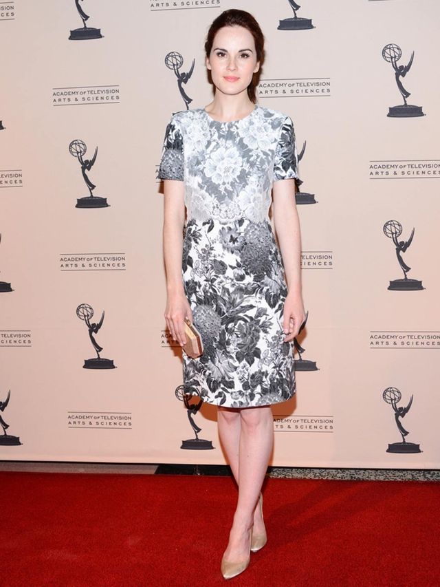 <p>Michelle Dockery teams her monochrome floral print dress with gold accessories for the Emmy awards reception party in Hollywood, September 2012.</p>
