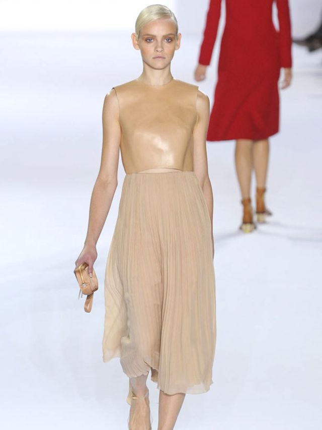 <p>Wearing ballerina pumps, a dancer aesthetic was created by long tulle and chiffon skirts worn with skin-tight leotard tops. Asymmetric dresses draped around the bust like a bandage and skirts were transparent to show gym-slim knickers underneath. </p><