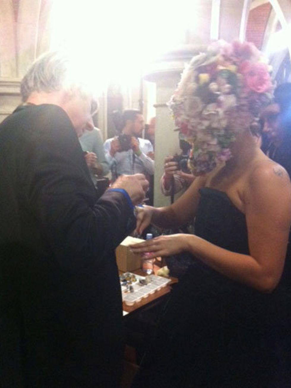 <p>Philip Treacy shows Lady Gaga the huge blue ring she will be wearing on the catwalk</p>