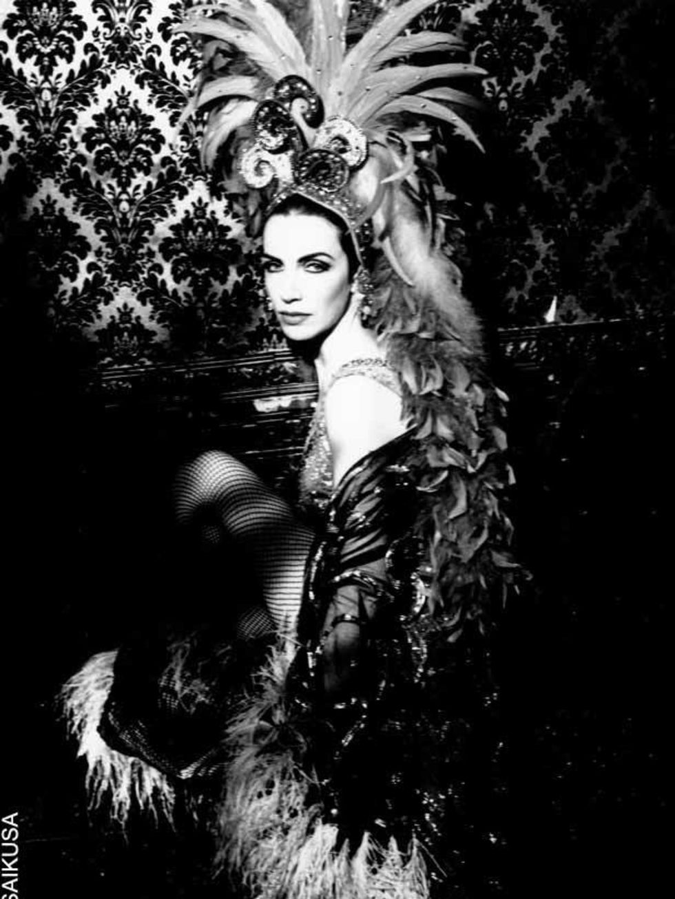 <p><a href="http://www.elleuk.com/content/search?SearchText=Annie+Lennox&amp;SearchButton=Search">Annie Lennox</a> poses for the camera in burlesque garb in 1991</p>