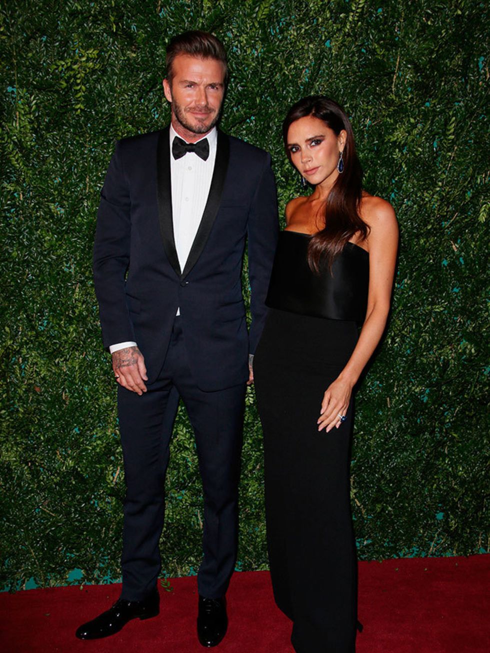 David Beckham and Victoria Beckham wearing a gown from her collection to the Evening Standard Theatre Awards in London, November 2014.