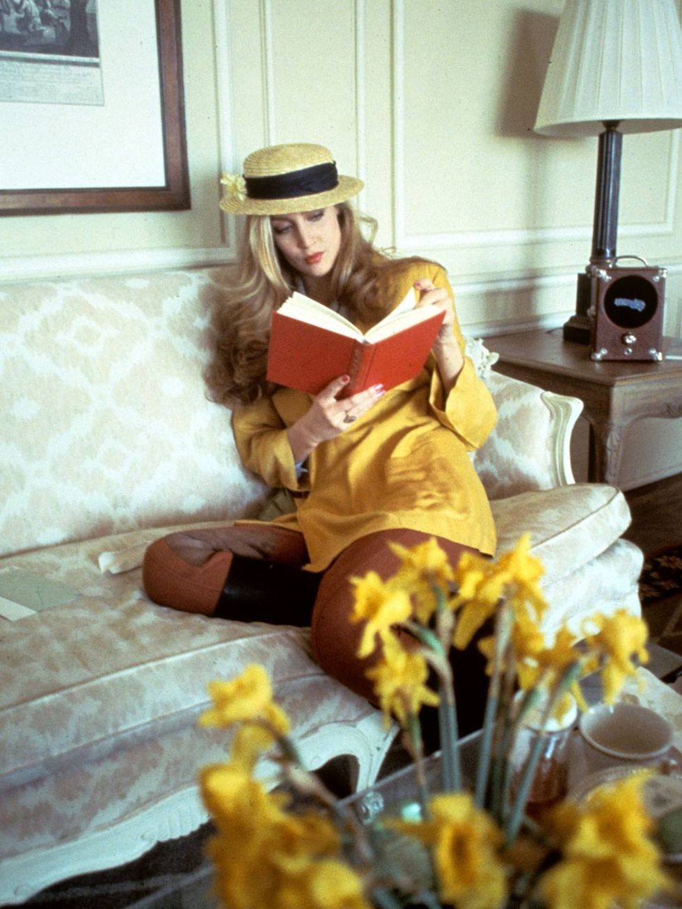 <p>Jerry Hall wears a yellow jacket teamed with a boater hat in 1978</p>