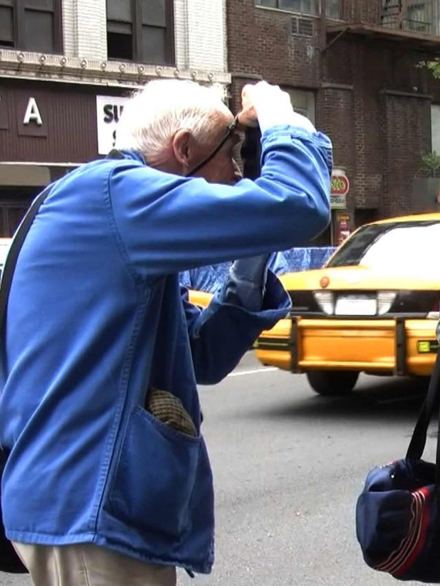 <p>Photographer Bill Cunningham at work on the New York City streets.</p>