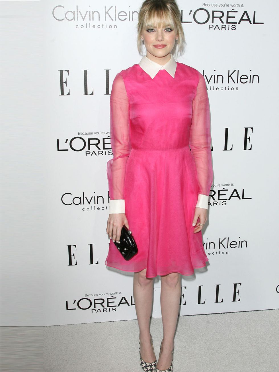 <p>Emma Stone in a pink Valentino dress and clutch Ferragamo heels, Neil Lane earrings, and Irene Neuwirth rings.</p>