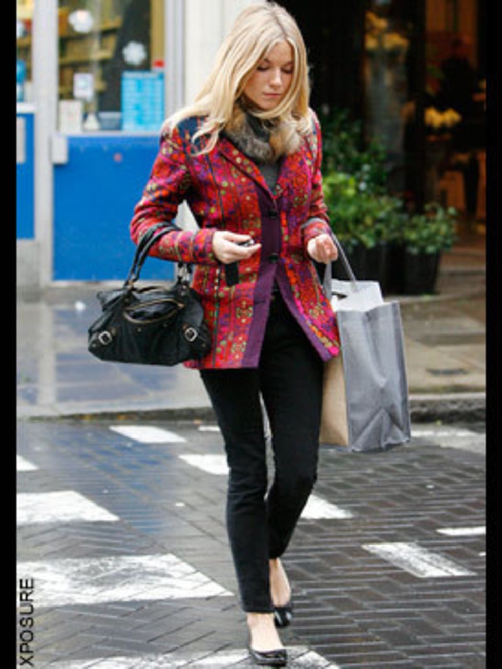 <p>Ms Miller beats the chill with a flash of colour with this rainbow-bright jacket worn over her trademark black skinny jeans </p>