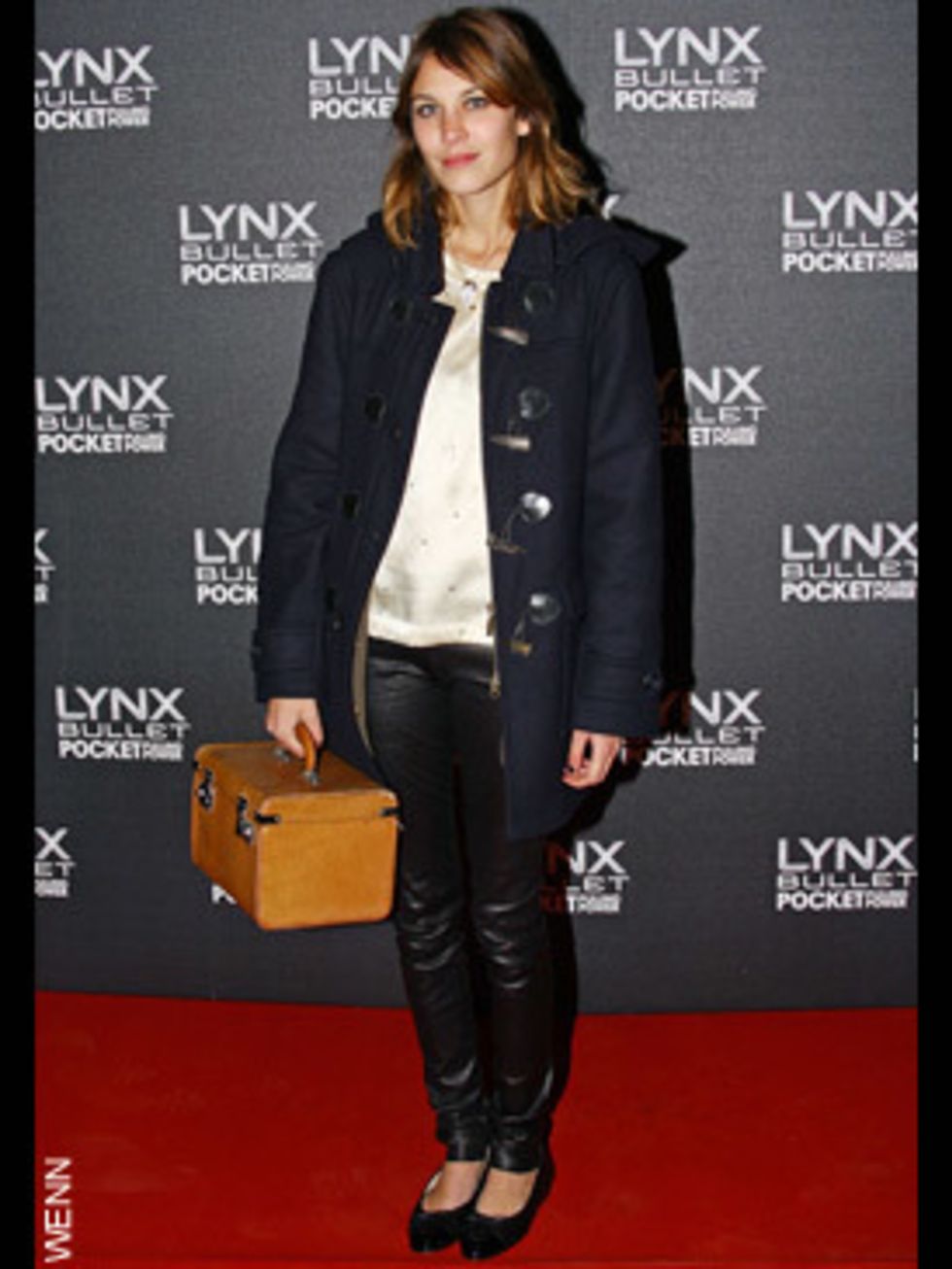 <p>Ever the vintage style queen, Alexa dresses down her glam wet-look leggings with a duffle coat and an over-sized box bag</p>