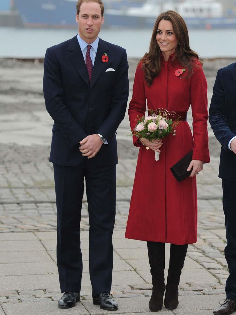 <p>Kate wore the same red LK Bennett coat on a visit to a UNICEF Emergency Supply Centre in Copenhagen with Prince William, this time accessorising with a black clutch and suede Stuart Weitzman boots.</p>