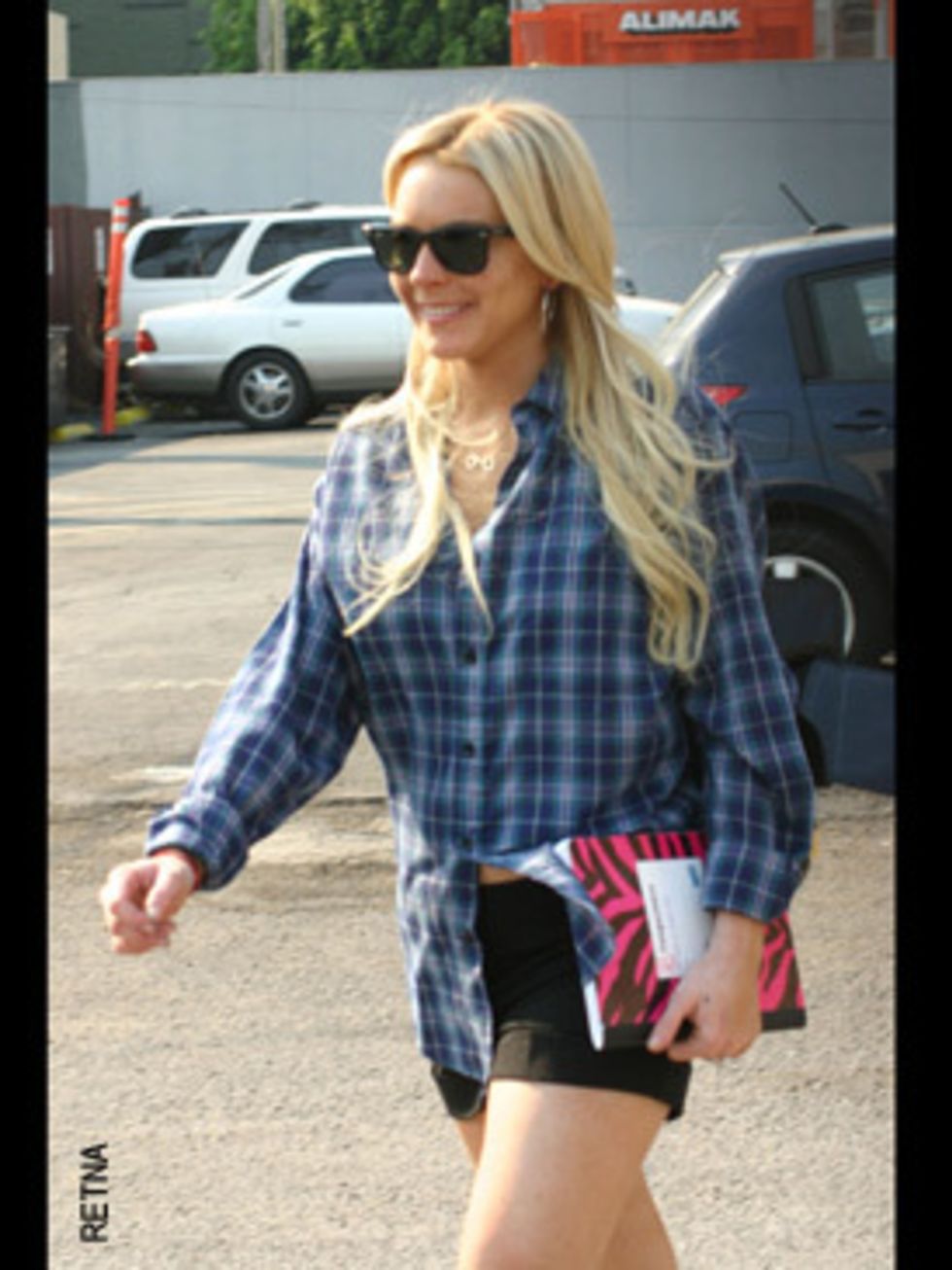 <p>Lindsay accessories her checked shirt with an exercise book. Is it to make her look more serious despite that tiny skirt?</p>