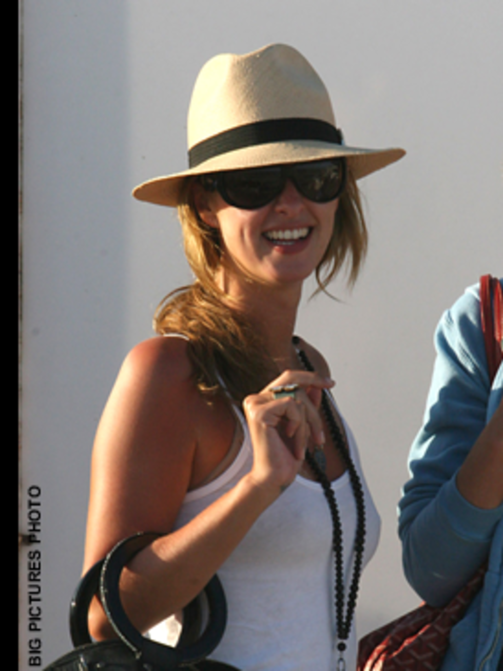 <p>Nicky avoids the over done L.A. look by accessorising with a cream and black straw trilby</p>
