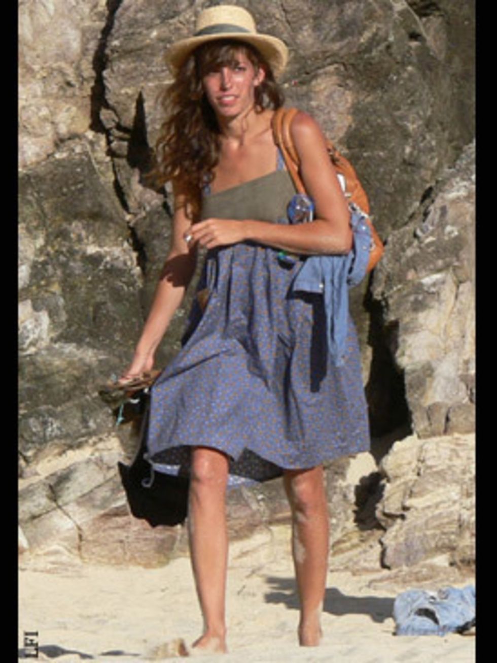 <p>Lou Doillon takes a bit of street-chic to the beach by shunning a traditional, floppy straw hat for this modern boater.</p>