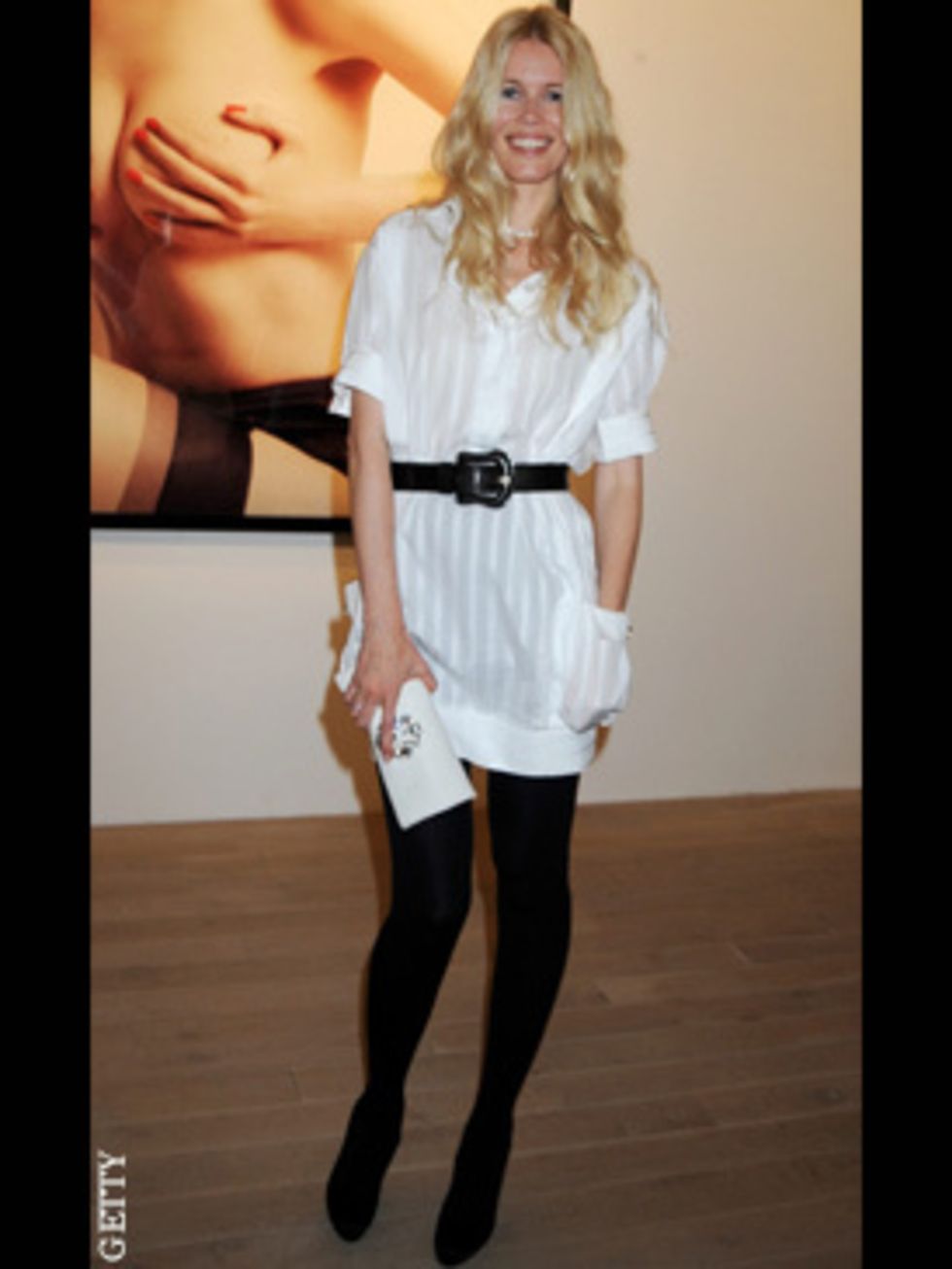 <p>Claudia chose understated monochrome to pose in front of a very sexy shot of herself at Mario Testino's latest exhibition of photographs in London</p>