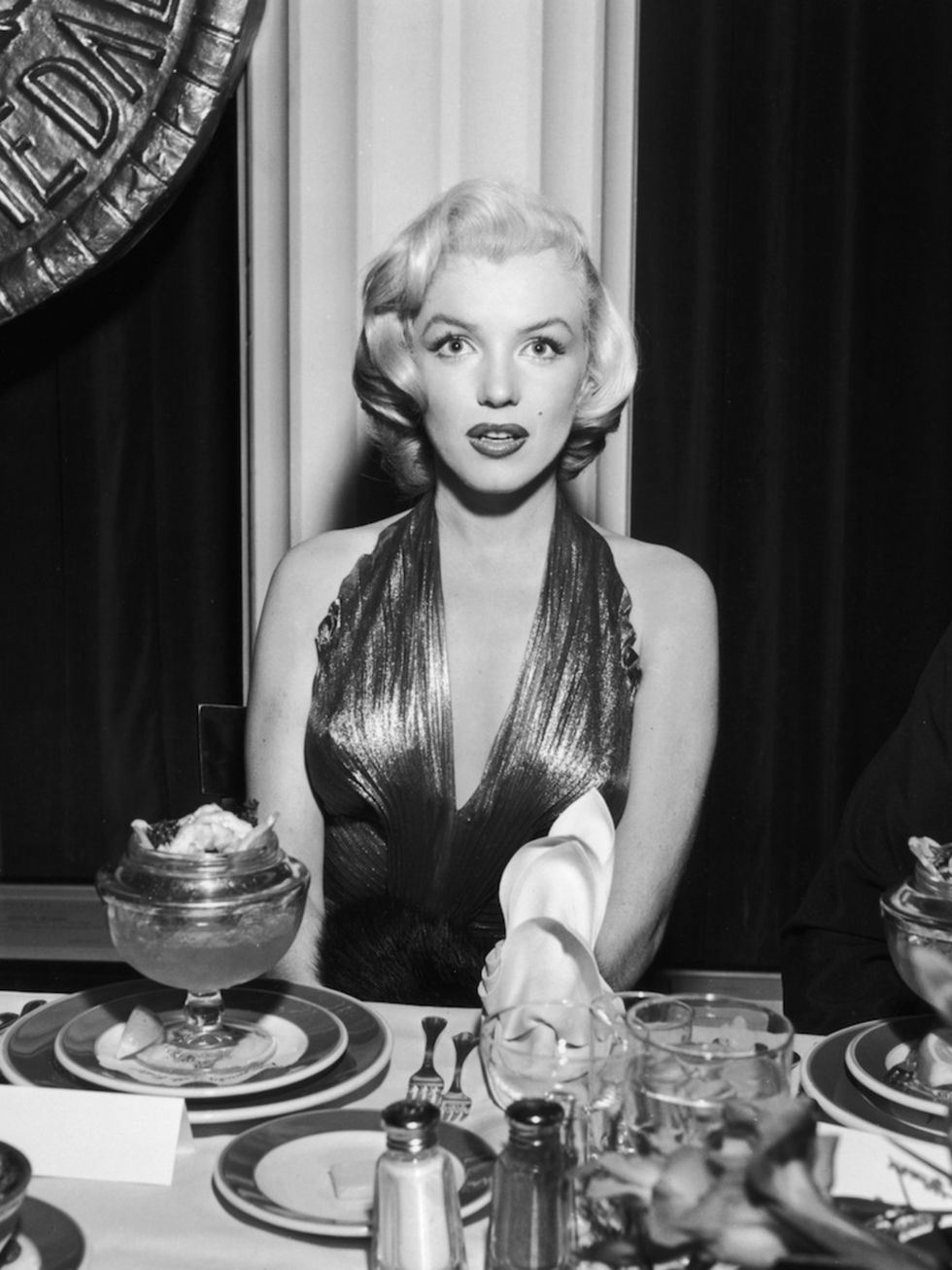 <p>At a banquet table during a Photoplay Gold Medal Awards dinner. Monroe won two of the magazine's awards. In 1952 she won a special award and in 1953 she won Most Popular Female Star</p>