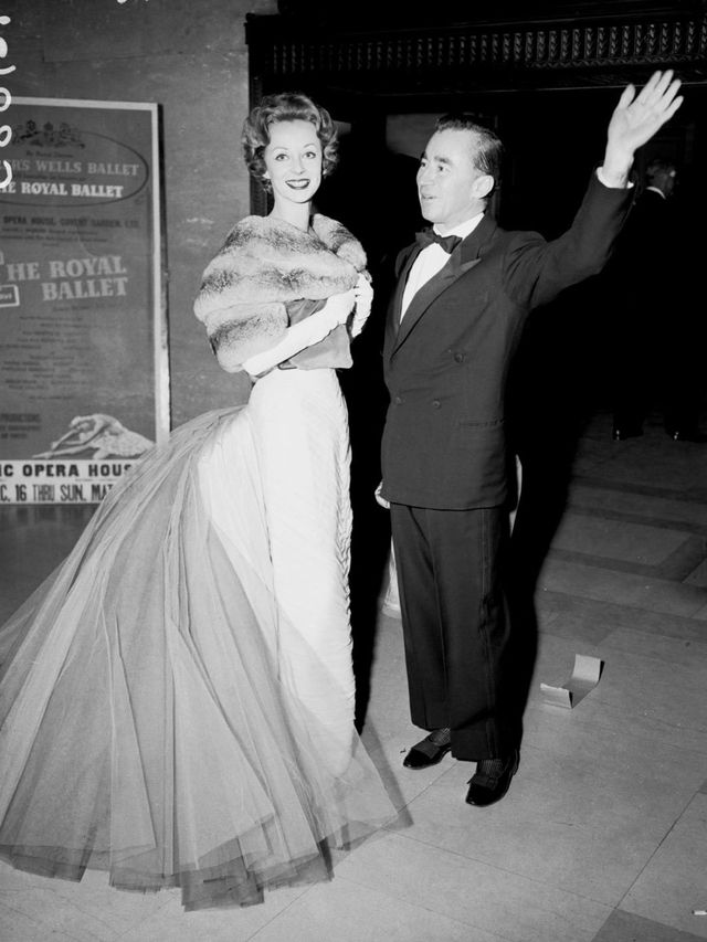 <p>Charles James pictured in 1957 with Mrs Howard Reilly, who wears one of James' gowns.</p>