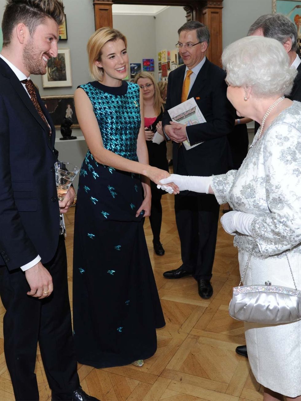 <p>Henry Holland and Agyness Deyn meet the Queen</p>