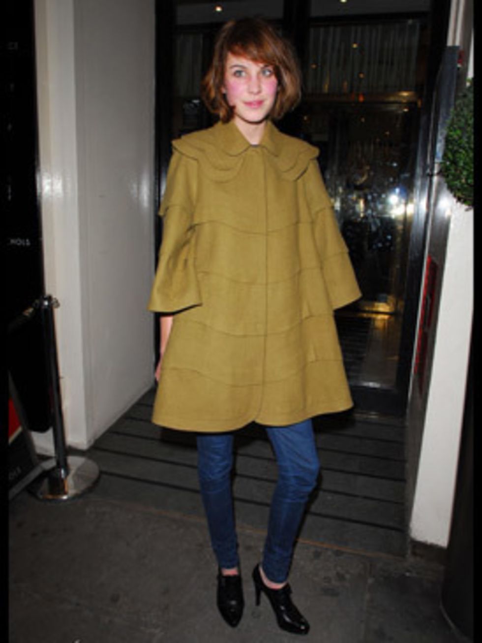 <p>Alexa's our caped fashion crusader in her mustard cloak, expertly teamed with super skinny jeans and high heels.</p>