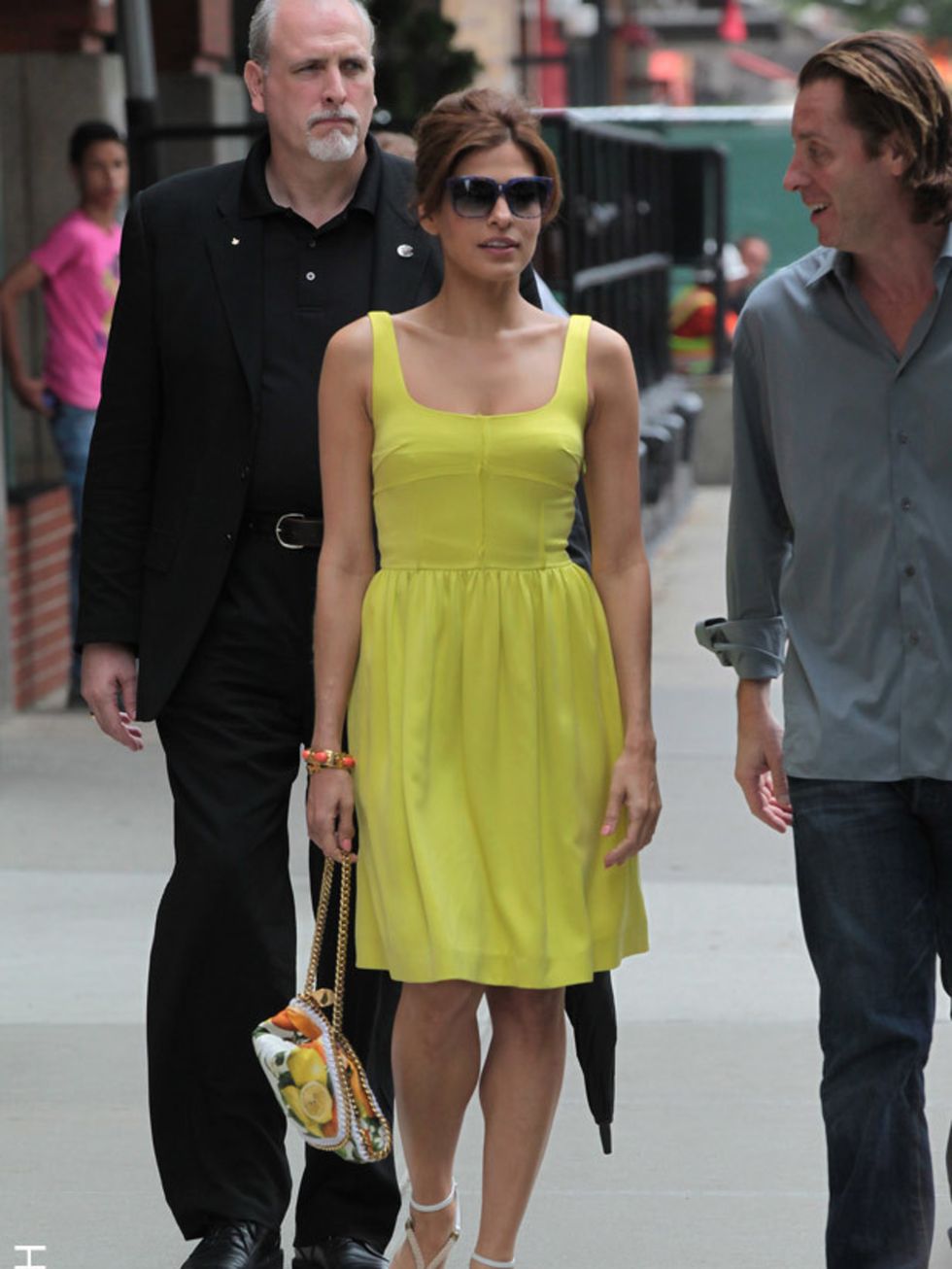 <p>Eva Mendes leaves her TriBeCa hotel wearing a sleeveless yellow dress and lemon print bag by <a href="http://www.elleuk.com/catwalk/collections/stella-mccartney/spring-summer-2011">Stella McCartney</a> finishing her look with Chloé wedges, June 2011.</