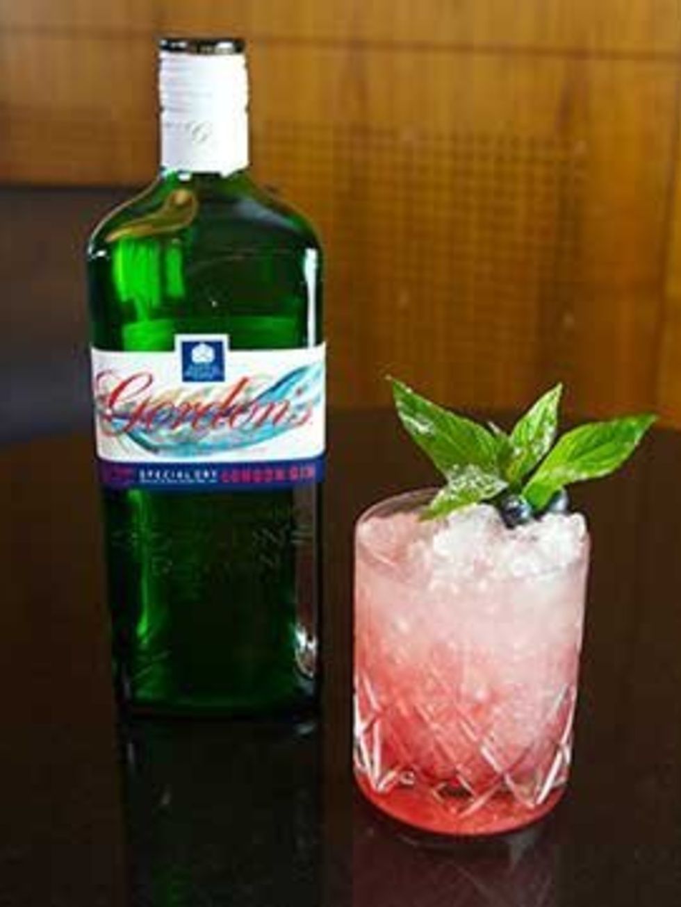 <p>A Gordon's Gin Ten Green Bottles design with a Sky Blue Feather cocktail</p>