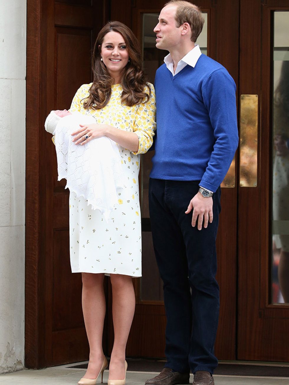 The first picture of the Duke and Duchess of Cambridge with their baby daughter - the new princess - around 10 hours after her birth. Kate wore a bespoke silk shift dress with buttercup print by Jenny Packham and, unlike with the birth of Prince George, t