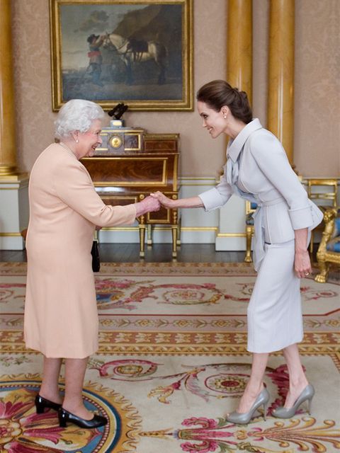 <p>Angelina Jolie is presented with the Insignia of an Honorary Dame Grand Cross of the Most Distinguished Order of St Michael and St George by Queen Elizabeth II, October 2014.</p>