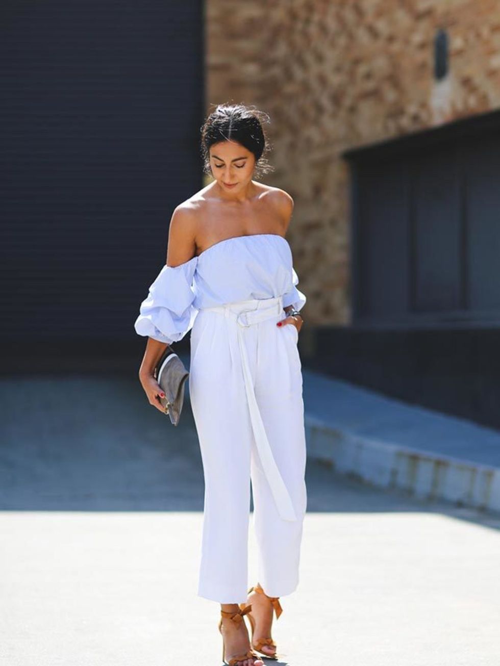 Nausheen Shah wearing a Johanna Ortiz top, Celiné trousers and carrying a Clare Viver clutch