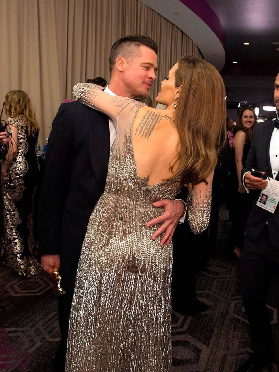 <p>Brad Pitt and Angelina Jolie celebrate backstage at the Academy Awards 2014</p>