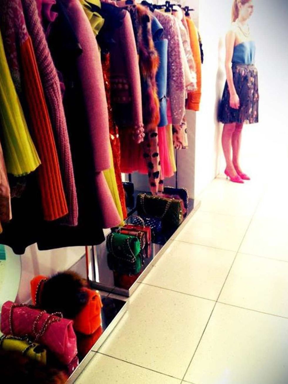 <p>A rail of clothes and a model in Moschino Cheap &amp; Chic's A/W '12 collection</p>