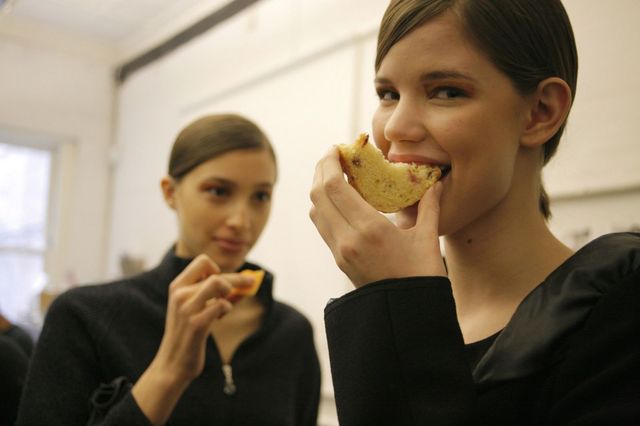 models eating backstage at fashion show