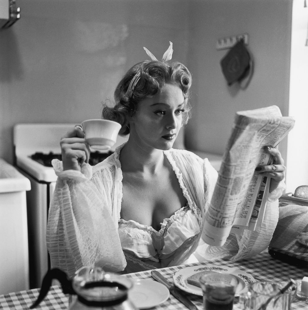 Woman drinking coffee and kitchen table | ELLE UK