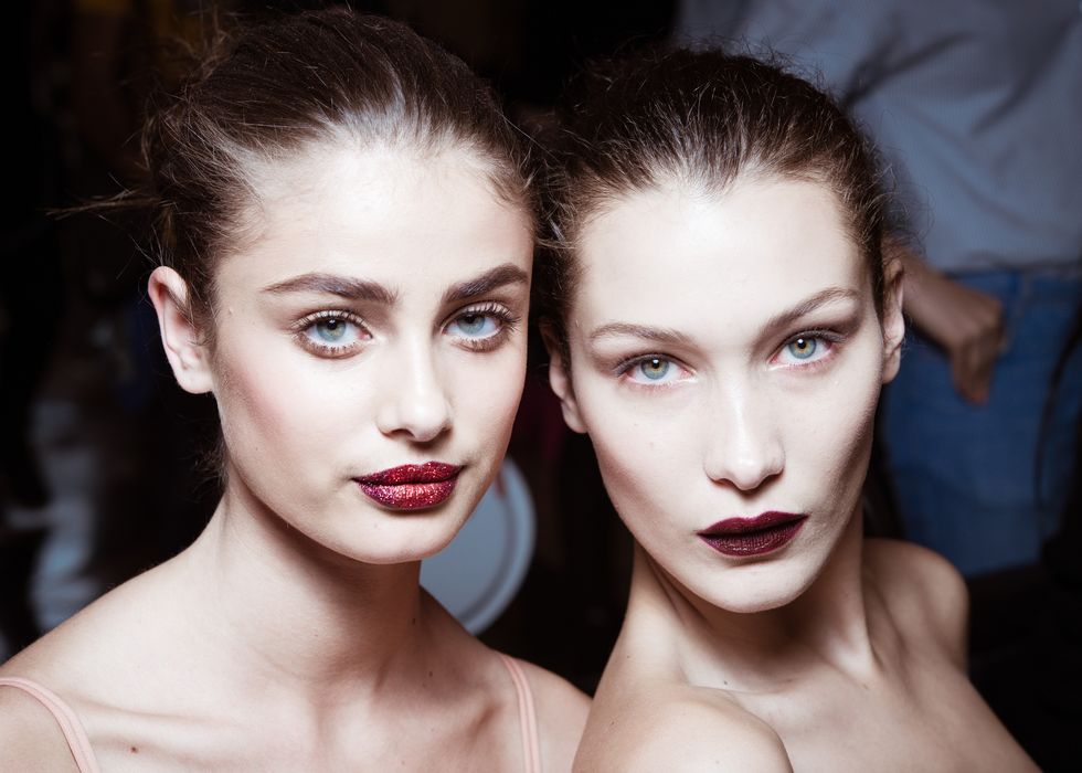 Taylor Hill and Bella Hadid backstage wearing lipstick | ELLE UK
