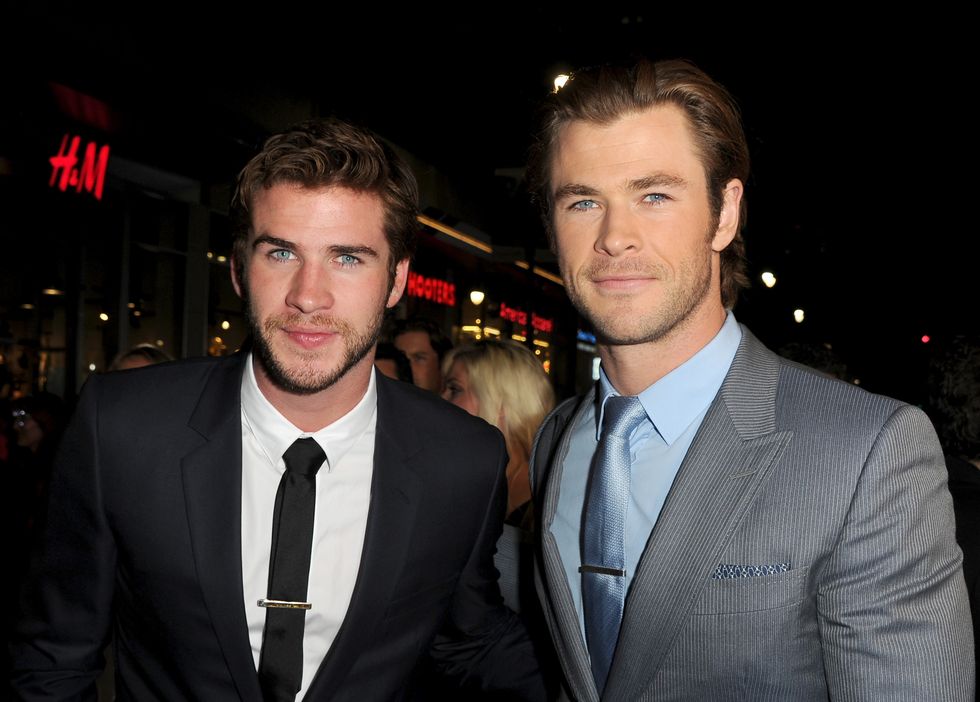 Liam and Chris Hemsworth pose for pictures | ELLE UK