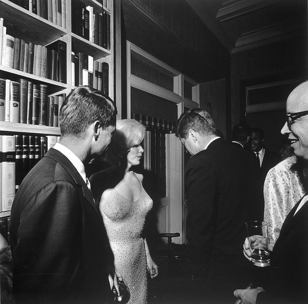 Marilyn Monroe stands between Robert Kennedy (left) and John F. Kennedy after her performance
