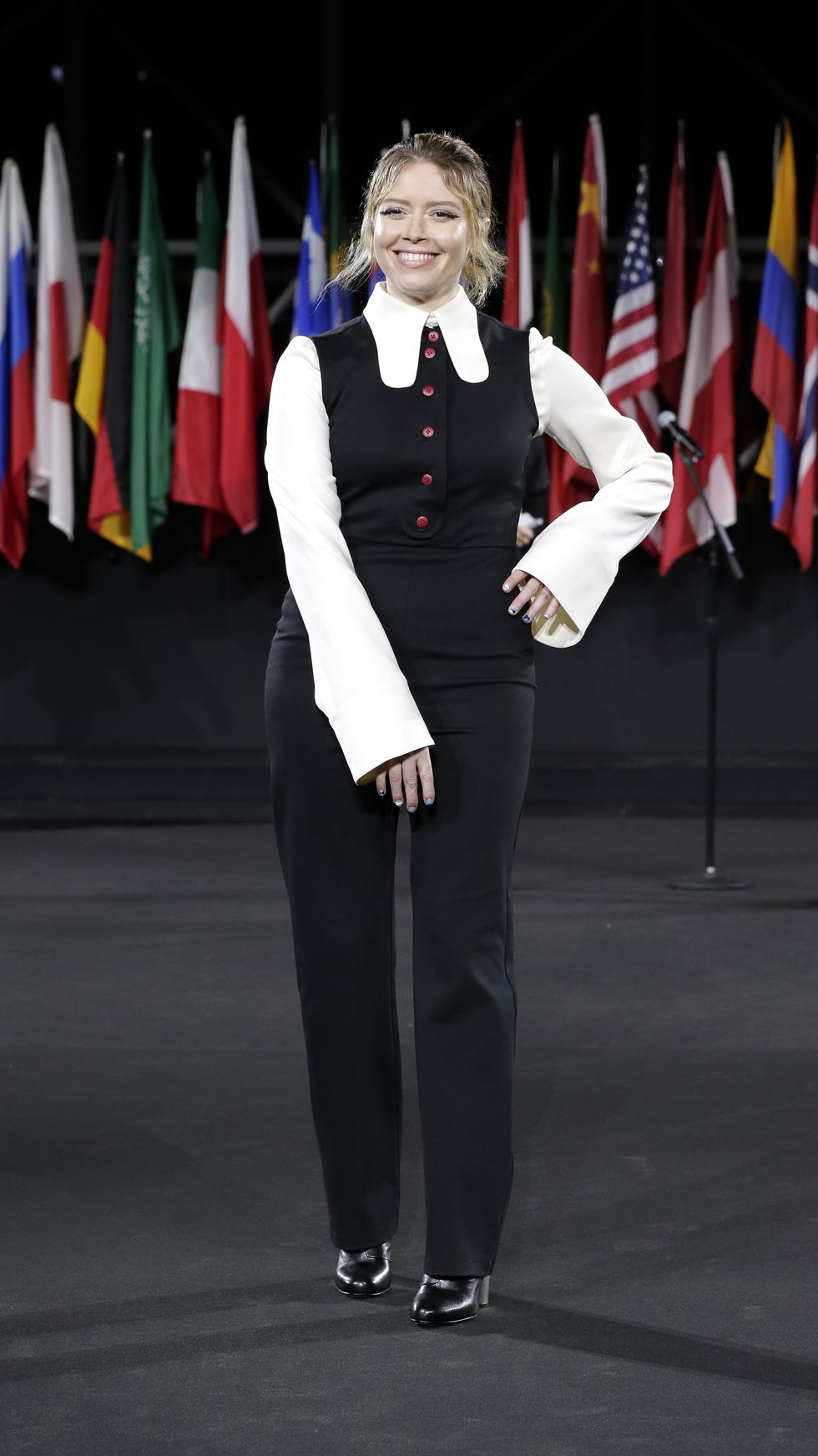 Flag, Standing, Uniform, Gesture, Government, Suit trousers, Flag of the united states, Pantsuit, Flight attendant, Official, 