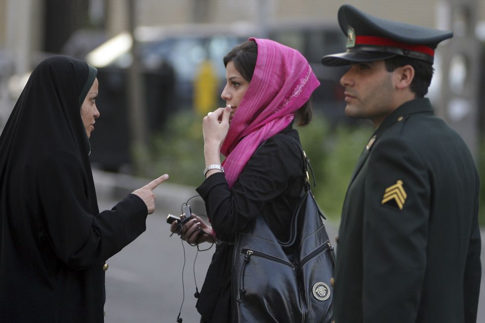 Police talk to woman in Iran on headscarves | ELLE UK