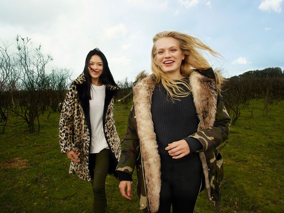 Outerwear, Happy, Mammal, People in nature, Fashion accessory, Beauty, Jacket, Fur, Long hair, Tights, 
