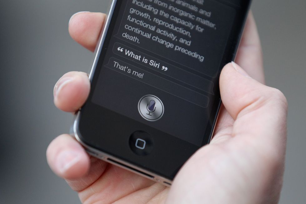 Siri being held by man on phone | ELLE UK