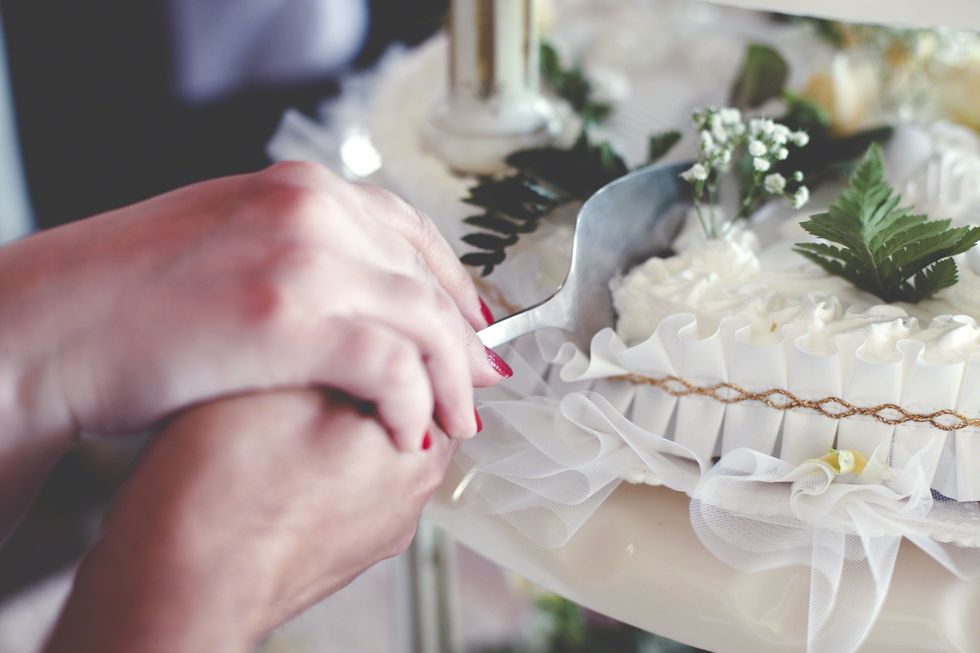 Finger, Nail, Dessert, Cake, Bridal clothing, Wedding dress, Wedding ceremony supply, Sweetness, Cut flowers, Embellishment, 