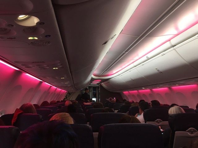 Aircraft cabin, Transport, Red, Air travel, Comfort, Passenger, Pink, Ceiling, Magenta, Airline, 
