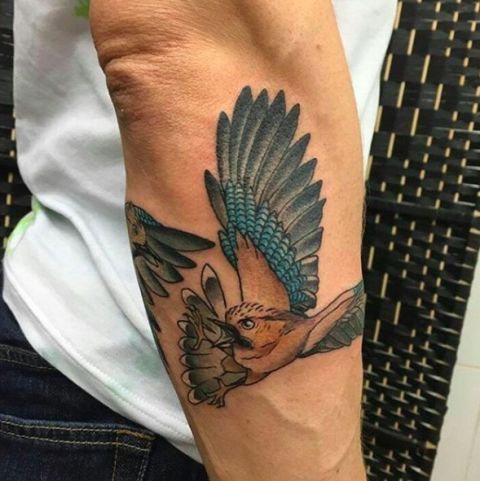 Tattoo, Wing, Wrist, Feather, Denim, Temporary tattoo, Paper, Natural material, Paper product, Bird, 
