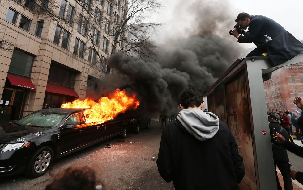 Press taking photos of riots | ELLE UK