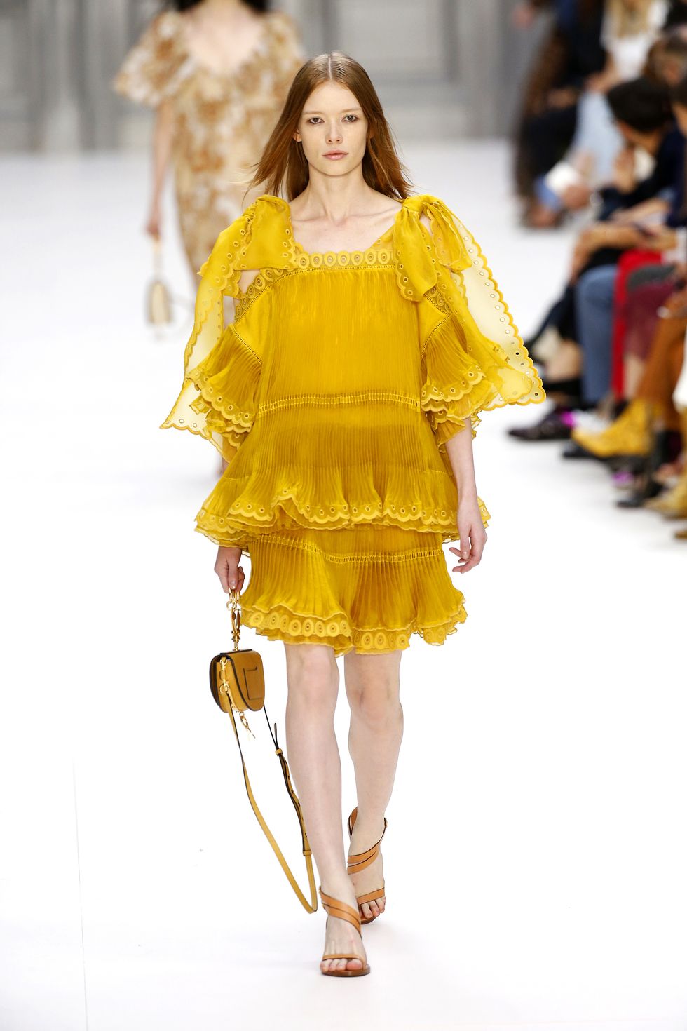 Yellow, Hairstyle, Shoulder, Joint, Dress, Fashion show, Style, Fashion model, Amber, One-piece garment, 
