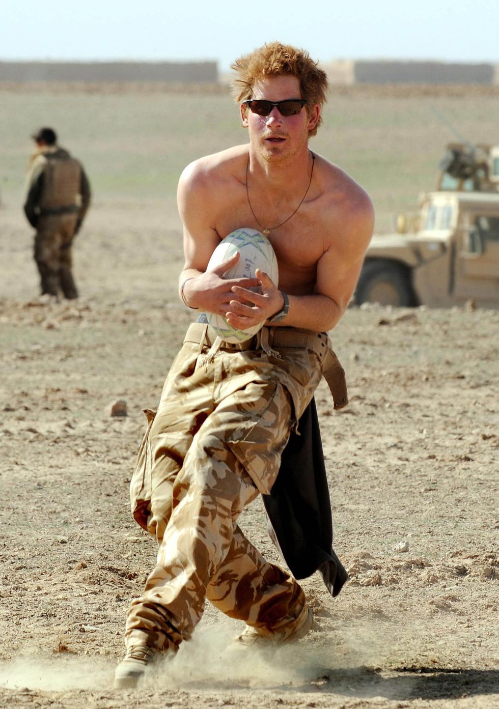 HELMAND PROVINCE, AFGHANISTAN - JANUARY 2: (NO PUBLICATION IN UK MEDIA FOR 28 DAYS) Prince Harry practices his rugby skills during a break in the desert on January 2, 2008 in Helmand Province, Afghanistan. (Photo by John Stillwell - POOL/Anwar Hussein Collection/WireImage)