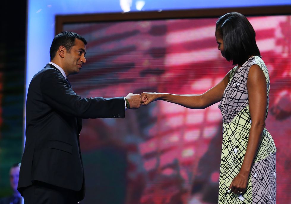 Kal Penn fist bumping Michelle Obama