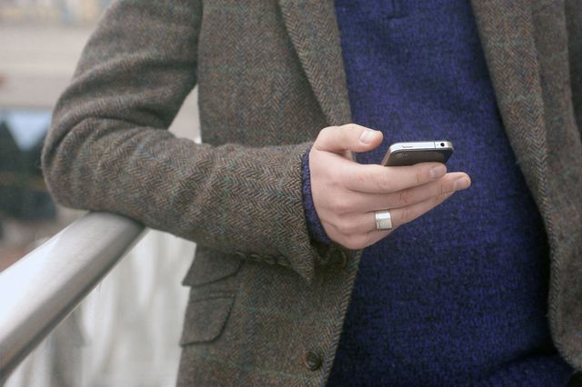 man on mobile phone texting - using new fertility app to test male fertility
