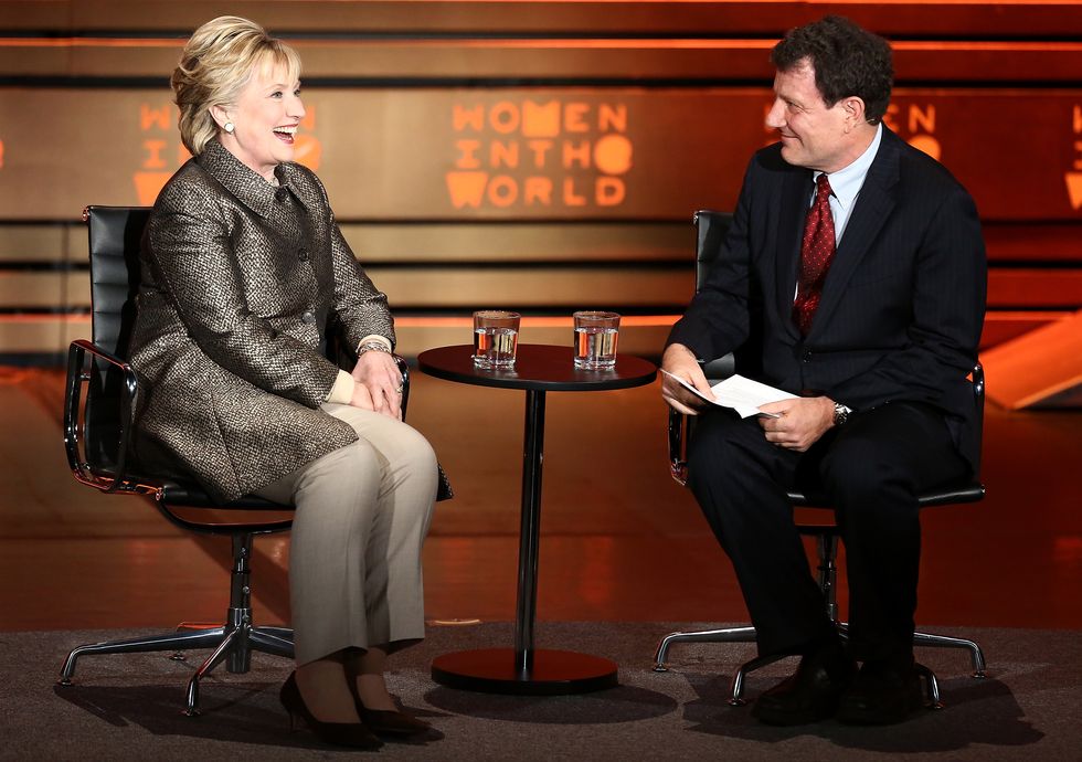 Hillary Clinton (L) speaks with journalist Nicholas Kristof on stage at the 8th Annual Women In The World Summit